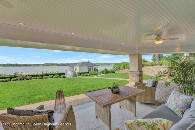 view of patio featuring a water view and ceiling fan