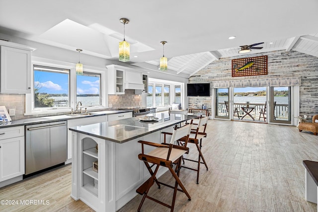 kitchen with white cabinetry, dishwasher, and a center island