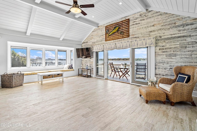 sitting room featuring plenty of natural light, high vaulted ceiling, and light hardwood / wood-style flooring