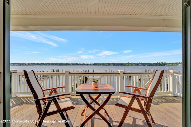 balcony featuring a deck with water view