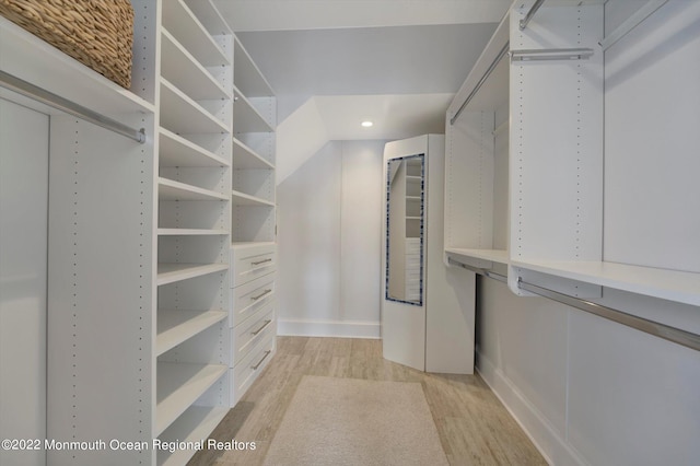 spacious closet with light hardwood / wood-style flooring