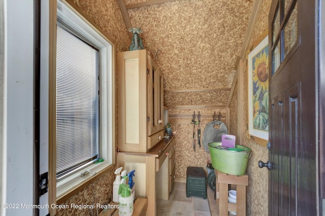 bathroom featuring tile patterned flooring and lofted ceiling