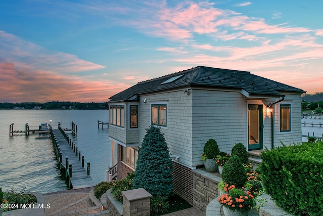 exterior space featuring a water view and a boat dock