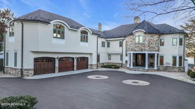 french country style house featuring a garage