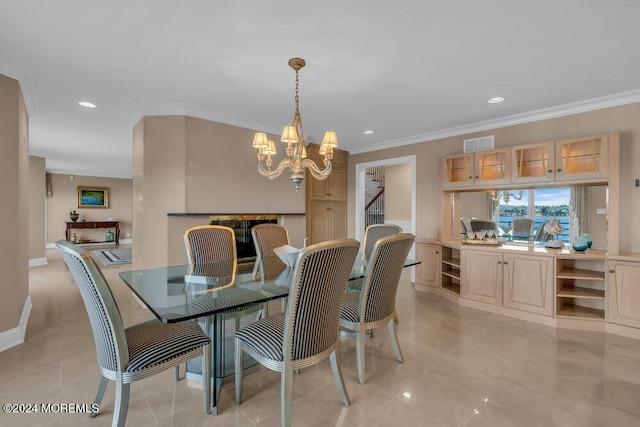 dining space with light tile patterned floors, an inviting chandelier, and crown molding