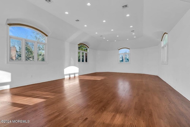 unfurnished living room with lofted ceiling and wood-type flooring