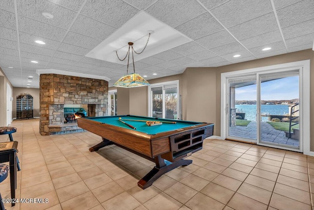 playroom with a fireplace, a water view, plenty of natural light, and billiards