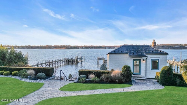 dock area featuring a lawn and a water view