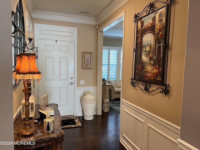 entrance foyer featuring crown molding and dark hardwood / wood-style flooring