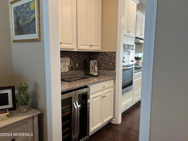 kitchen featuring white cabinetry, dark wood-type flooring, beverage cooler, light stone counters, and decorative backsplash