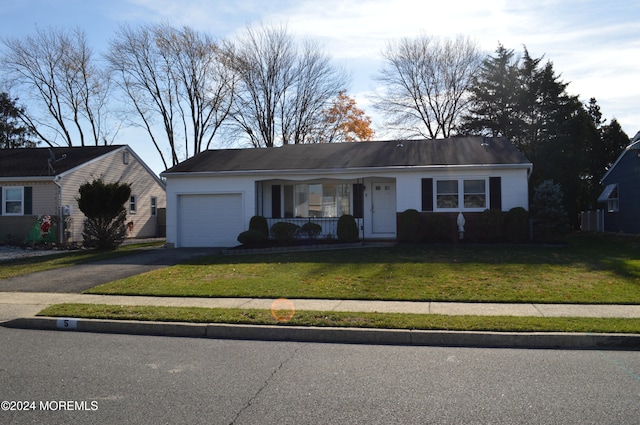 single story home featuring a garage, a porch, and a front yard