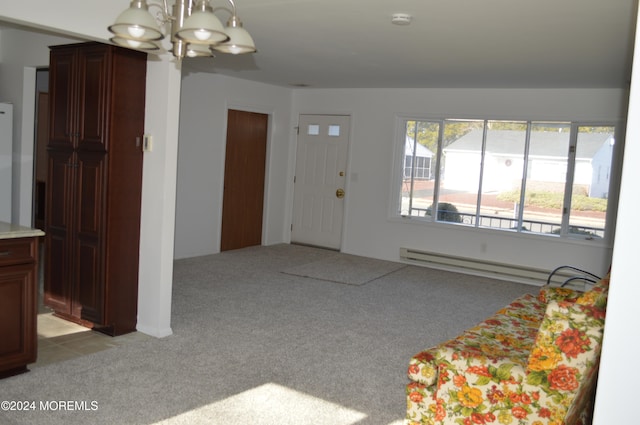 carpeted foyer entrance featuring a baseboard radiator and an inviting chandelier