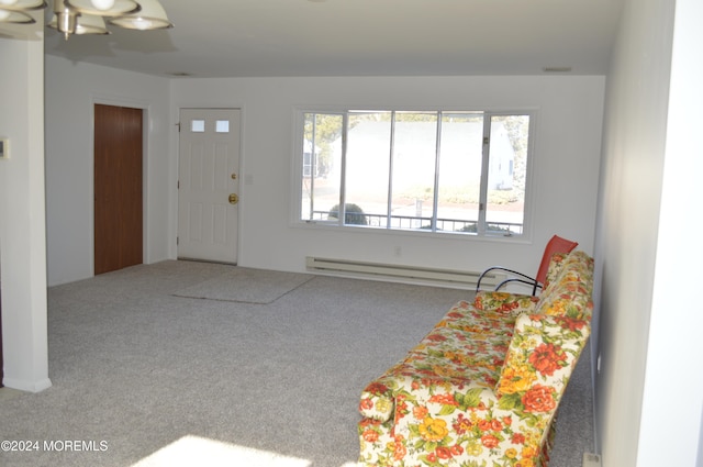 carpeted entryway with a baseboard radiator and a notable chandelier