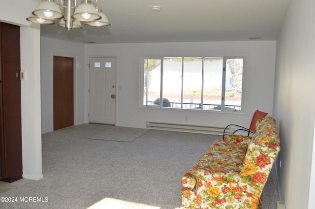 carpeted foyer entrance with an inviting chandelier and baseboard heating