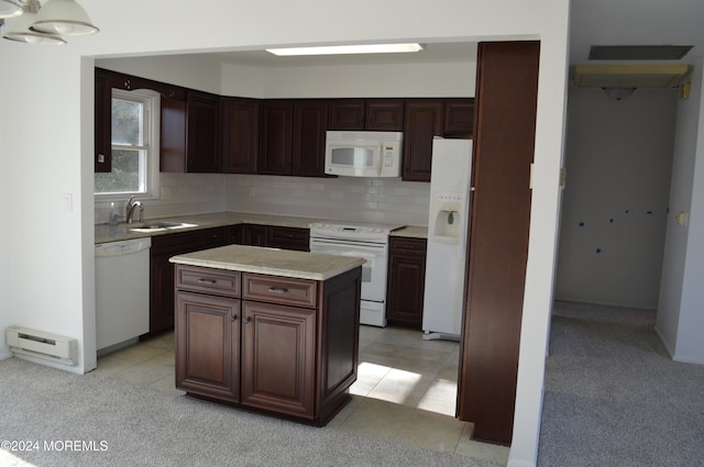 kitchen featuring white appliances, baseboard heating, sink, light tile patterned floors, and a center island