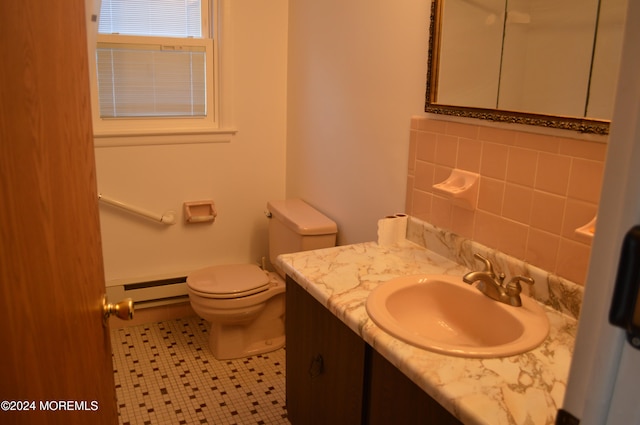 bathroom with vanity, a baseboard radiator, tile walls, tile patterned flooring, and toilet