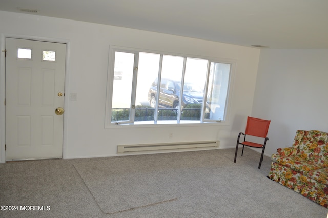 carpeted foyer entrance featuring a baseboard heating unit