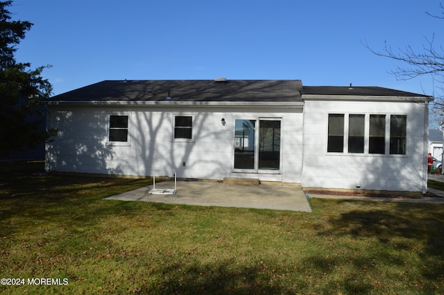 back of property featuring a lawn and a patio area