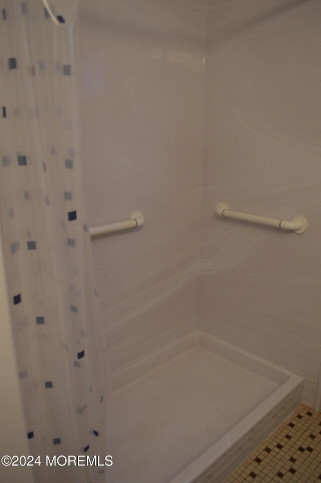 bathroom featuring tile patterned flooring and walk in shower