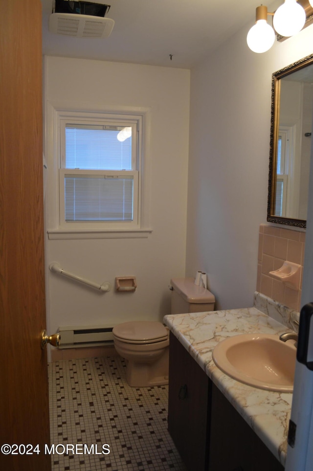 bathroom with baseboard heating, tile patterned flooring, toilet, decorative backsplash, and vanity