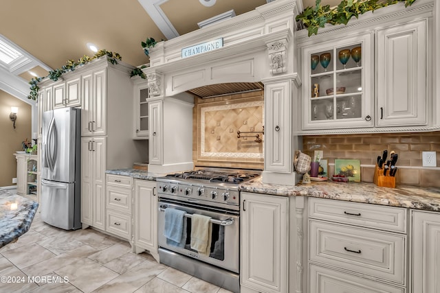 kitchen featuring decorative backsplash, stainless steel appliances, white cabinetry, and crown molding