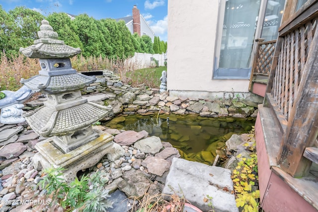 exterior details featuring a garden pond