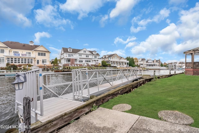 view of dock featuring a water view and a yard