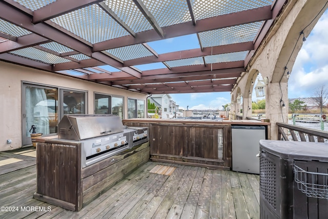 deck featuring a pergola and grilling area