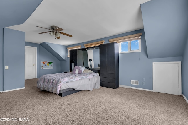 carpeted bedroom with ceiling fan and lofted ceiling