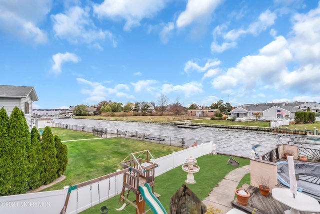 exterior space with a playground and a water view