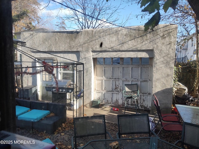 view of patio with area for grilling and a garage