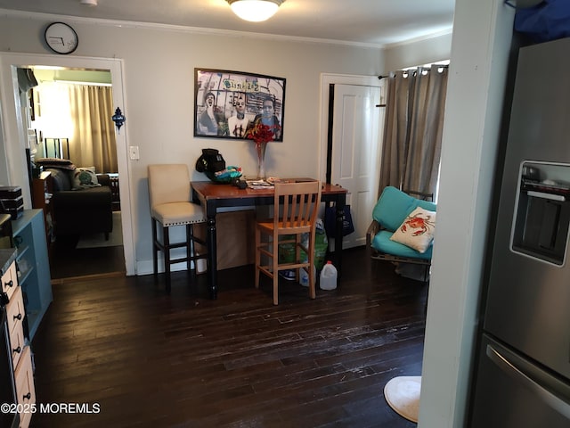 dining space with dark hardwood / wood-style floors and ornamental molding