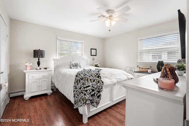 bedroom featuring a baseboard heating unit, ceiling fan, and dark wood-type flooring