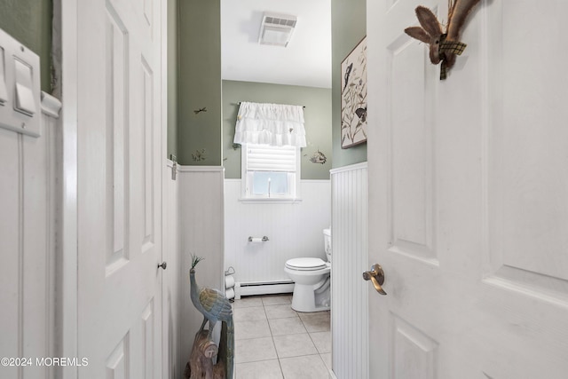 bathroom with tile patterned floors, toilet, and a baseboard heating unit