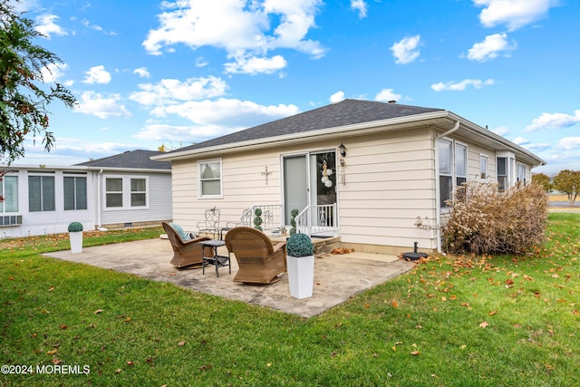 back of house featuring a lawn and a patio