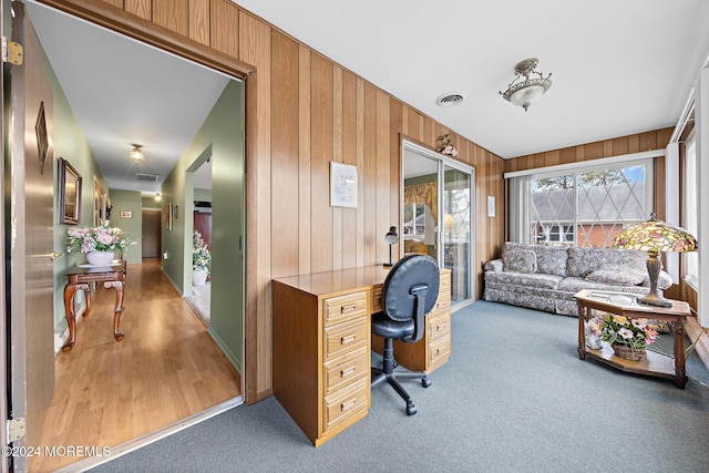 office area featuring wood walls and light hardwood / wood-style flooring