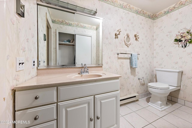 bathroom featuring tile patterned flooring, vanity, toilet, and baseboard heating