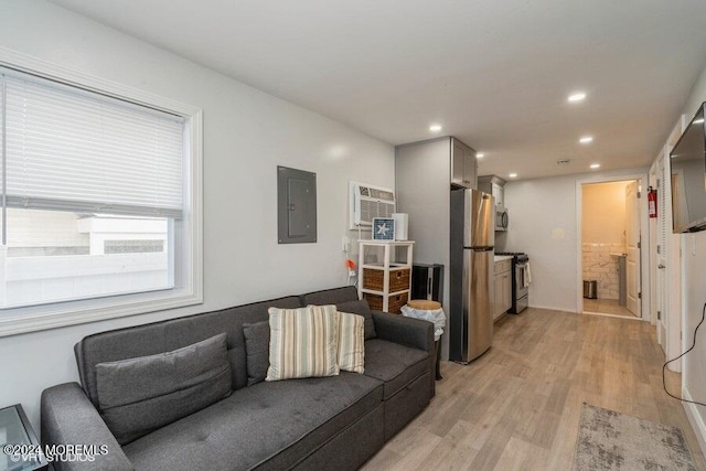 living room featuring electric panel and light wood-type flooring