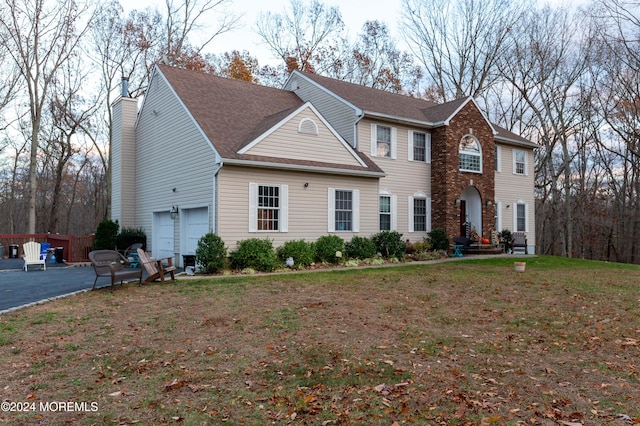 view of front of house featuring a front yard and a garage