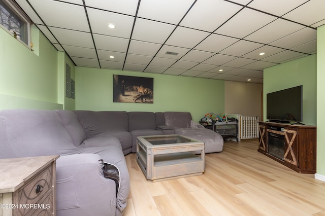 living room featuring a paneled ceiling and light hardwood / wood-style floors