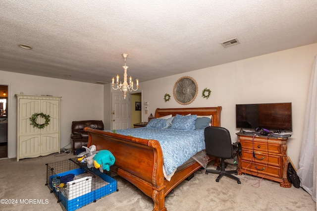 carpeted bedroom featuring a notable chandelier and a textured ceiling