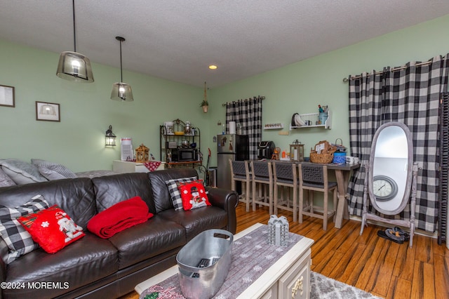 living room with hardwood / wood-style flooring and a textured ceiling