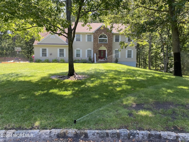 colonial-style house with a front yard