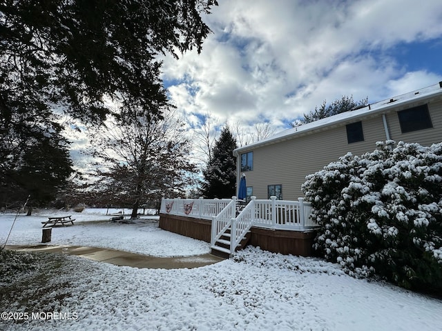 snowy yard featuring a deck