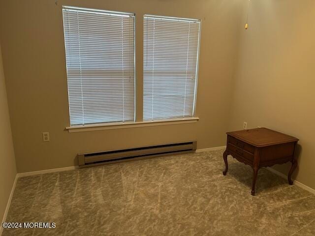 interior space featuring light colored carpet and baseboard heating