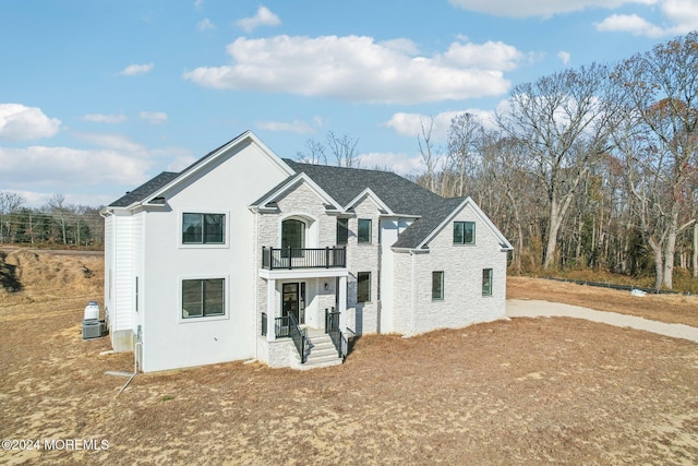 view of front of house featuring a balcony