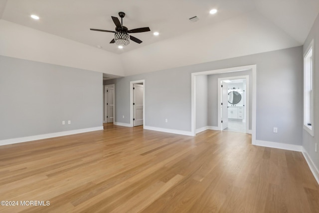 unfurnished living room featuring ceiling fan, light hardwood / wood-style floors, and vaulted ceiling