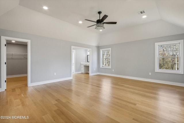 unfurnished living room featuring ceiling fan, light hardwood / wood-style floors, and vaulted ceiling