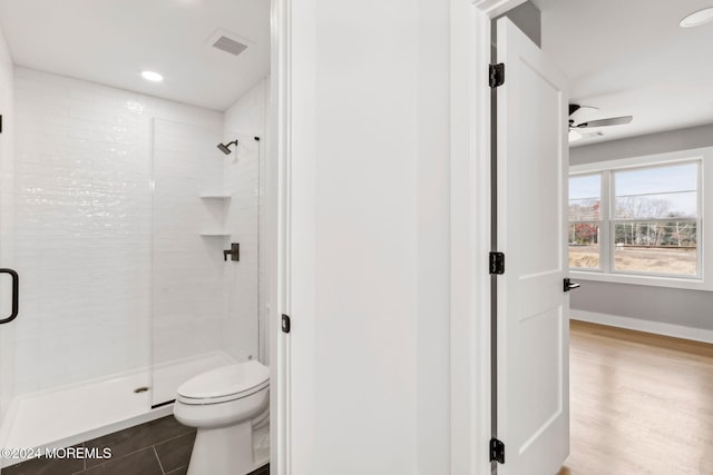 bathroom with walk in shower, ceiling fan, wood-type flooring, and toilet