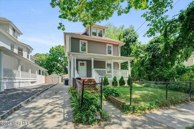 view of front of home with a porch and a front lawn